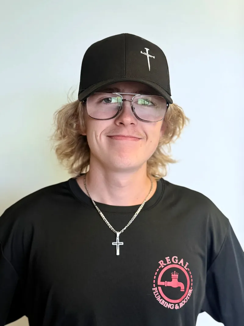 Ashton, Regal Plumbing & Rooter technician in Ontario, CA, smiling in company uniform