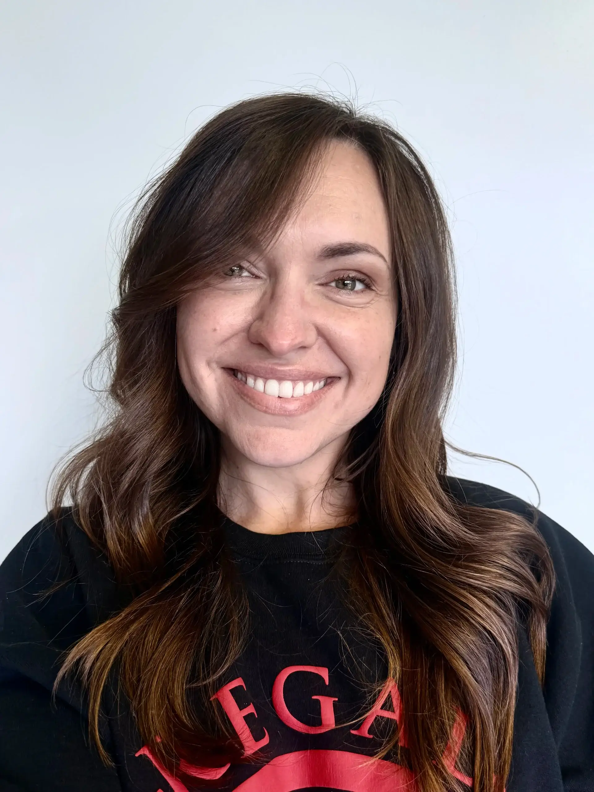 Natalie, office manager at Regal Plumbing & Rooter in Ontario, CA, smiling in company uniform