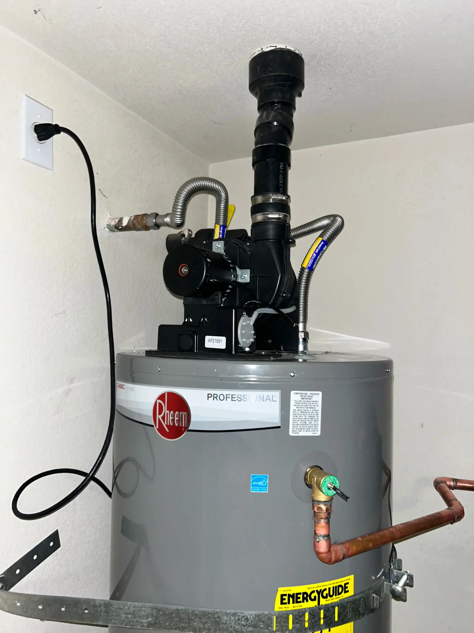 Rheem professional water heater installation with copper pipes and energy guide label by Regal Plumbing & Rooter in Upland, CA