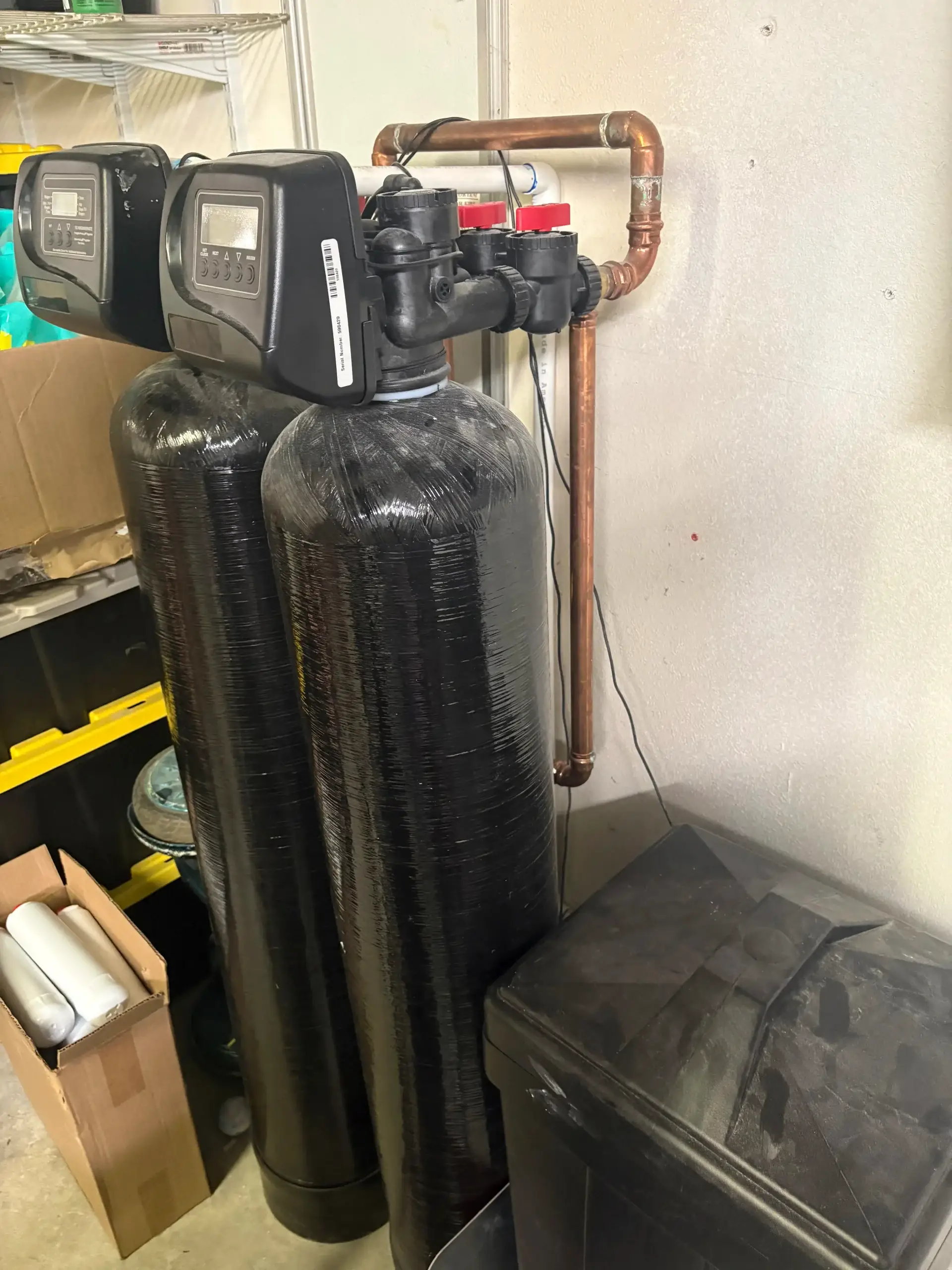 Water softening system with dual black tanks and control unit installed by Regal Plumbing & Rooter in Ontario, CA
